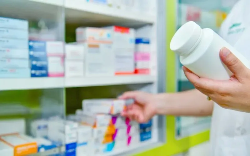 Pharmacist Holding Bottle Of Medicine Pharmacist Holding Bottle Of Medicine