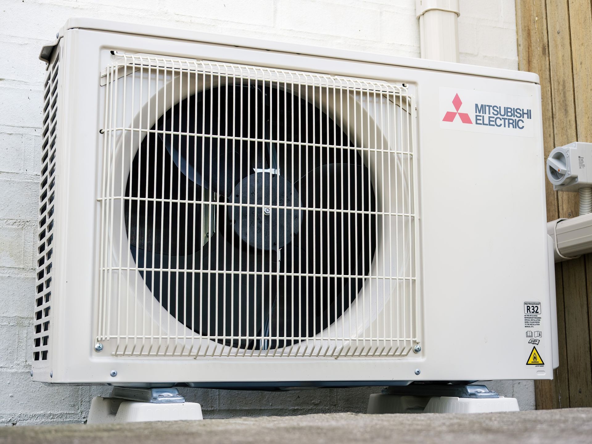 A mitsubishi electric air conditioner is mounted on a wall