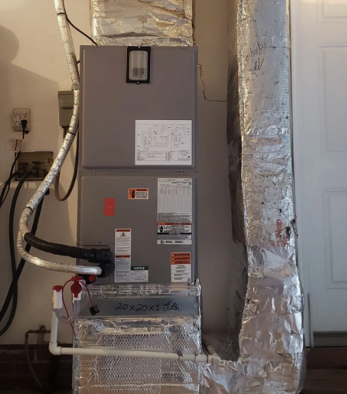 An air conditioner is sitting in the corner of a room.