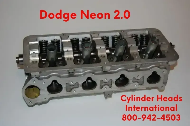A dodge neon 2.0 cylinder head sitting on a white surface