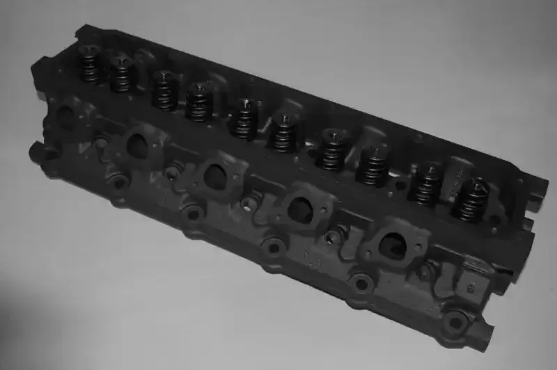 A black and white photo of a cylinder head