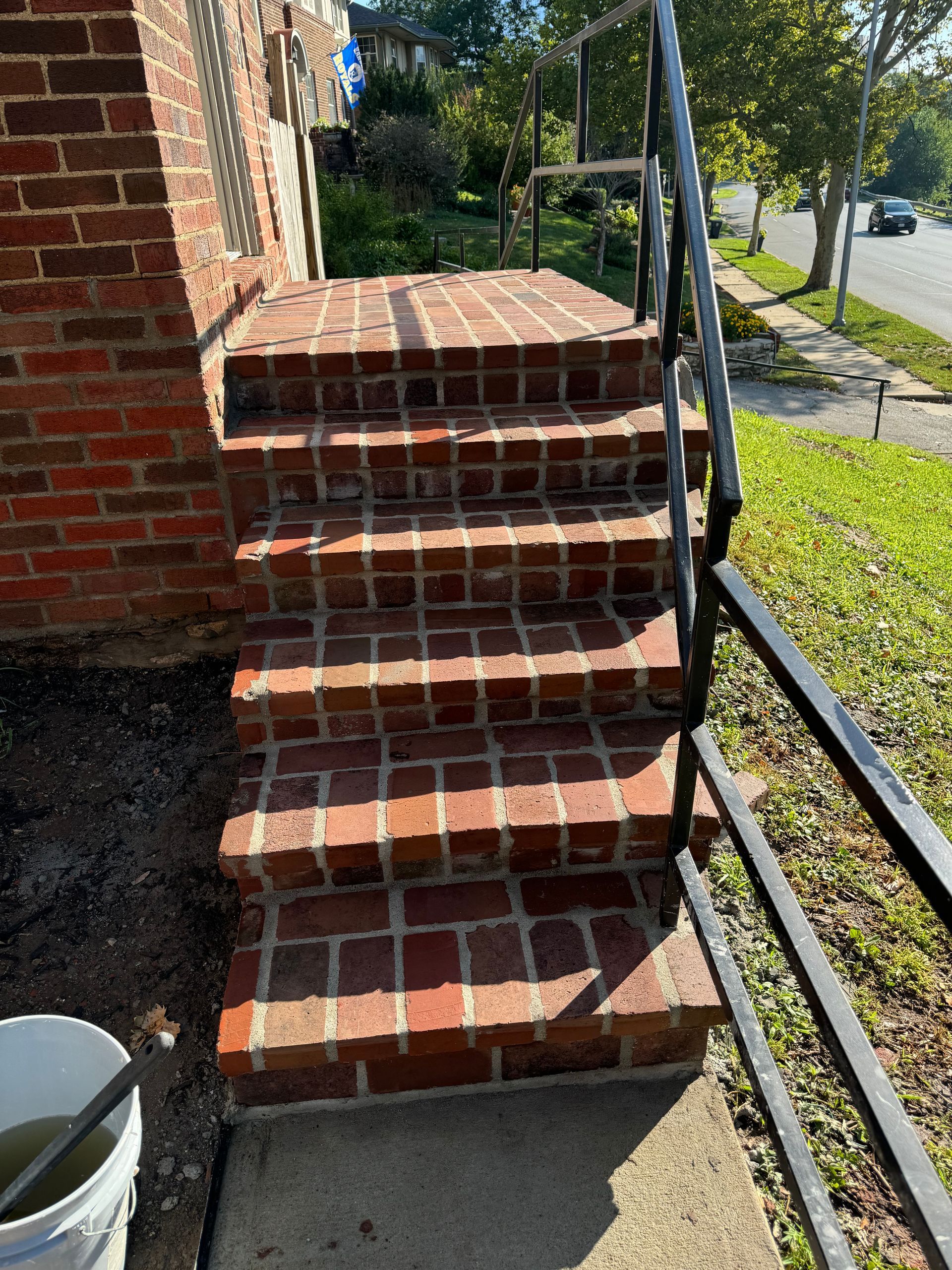 A set of brick stairs leading up to a brick building.