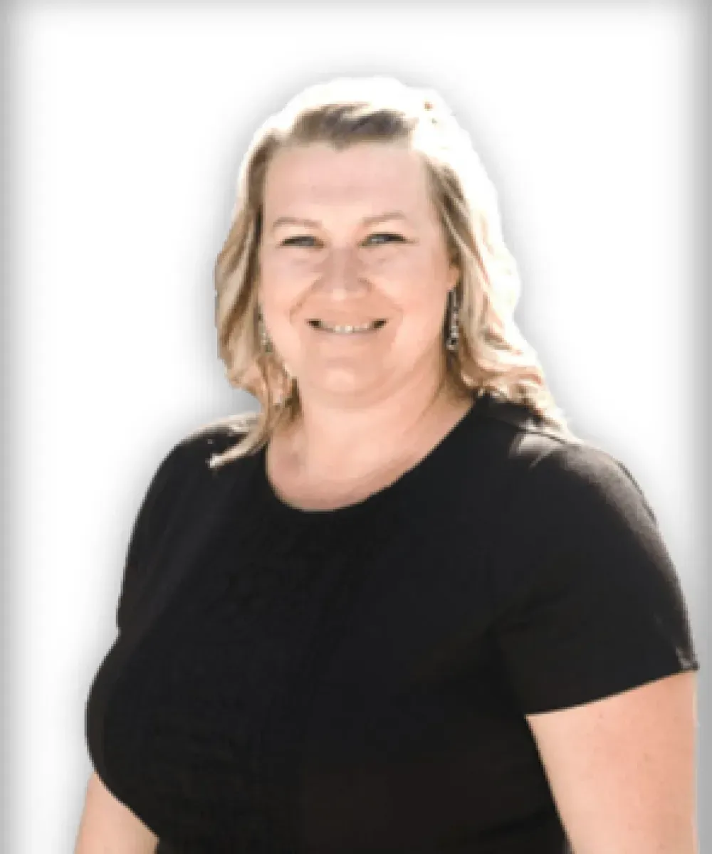 Smiling woman in a black shirt against a white background
