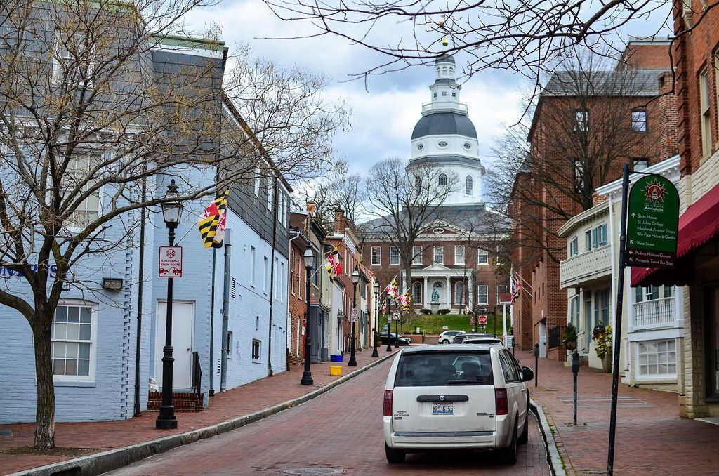The Maryland State House stands at the end of a historic, flag-lined street in downtown Annapolis