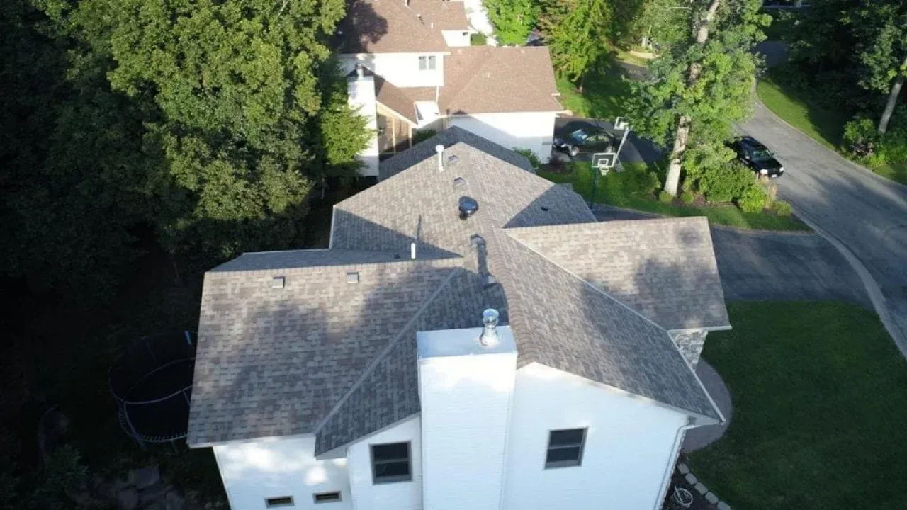 An aerial view of a multi-gabled asphalt shingle installation in Potomac, Maryland