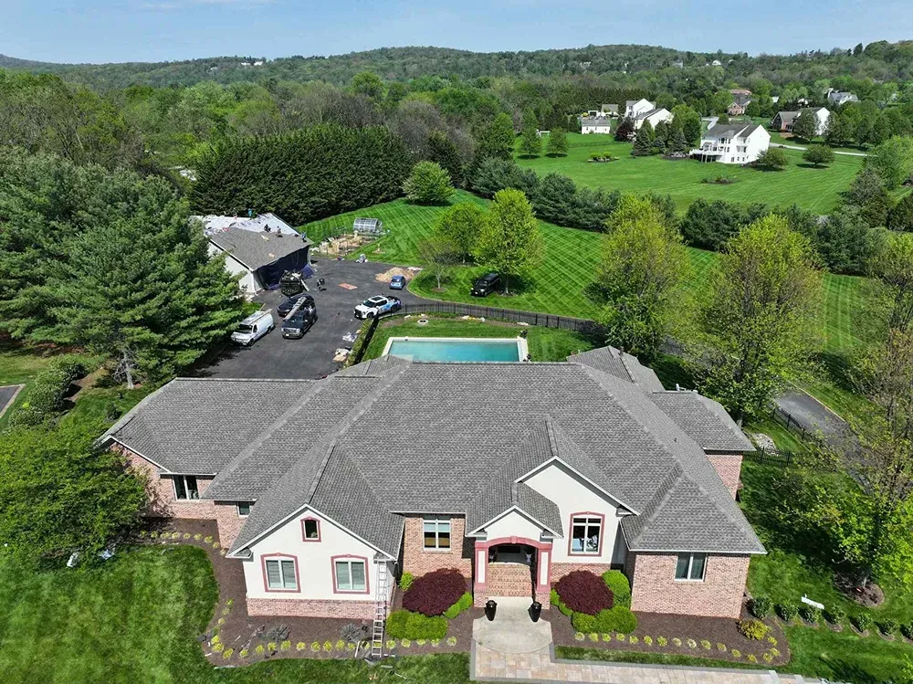New roofing installation on a large brick home in Maryland