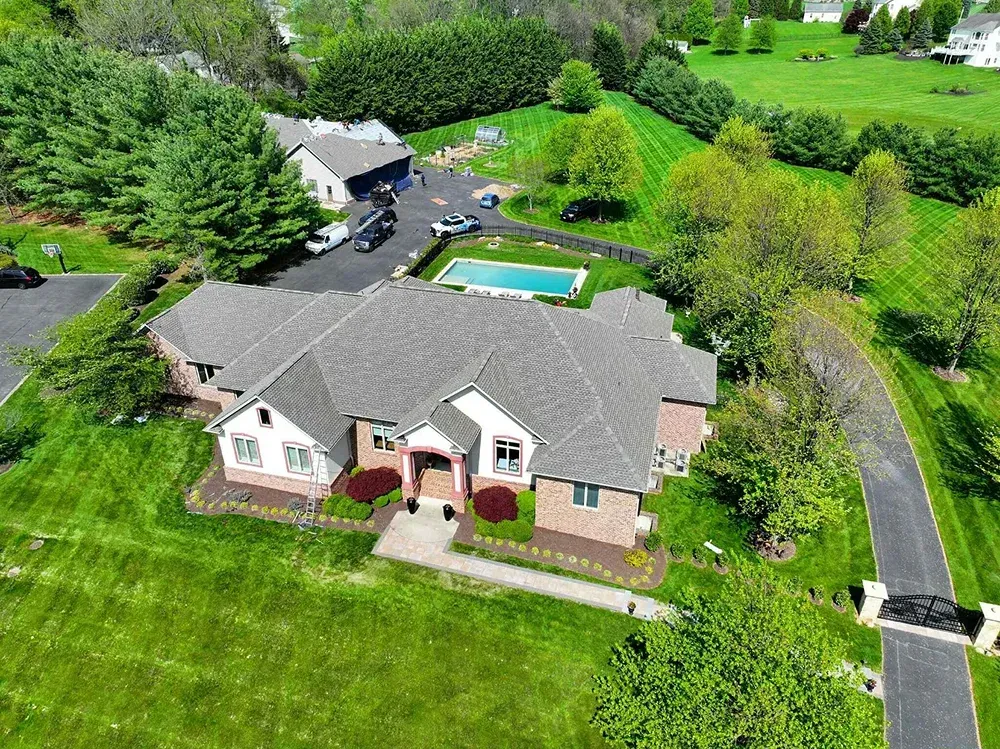 Shingle roof installation on a brick residential estate in Maryland.