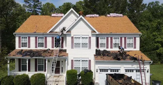 Removal of old shingles for a residential asphalt shingle roof replacement project in Maryland.