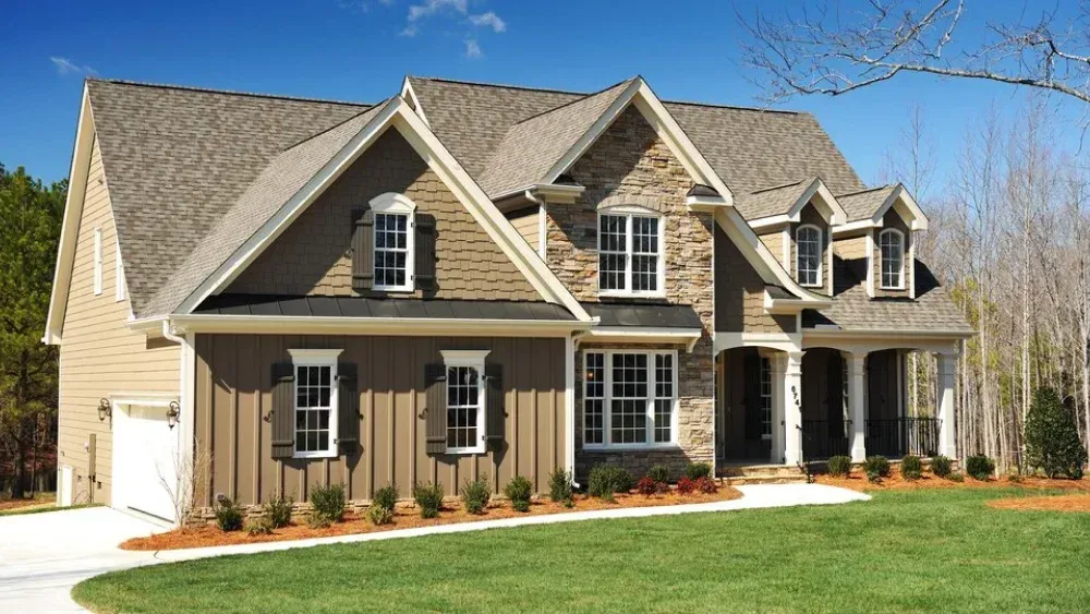 Architectural shingles installation on a brick and stone residential home in Maryland.
