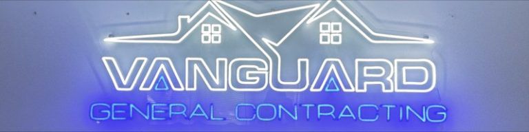 Neon sign for Vanguard General Contracting, white logo of a house with the company name, on a blue background.