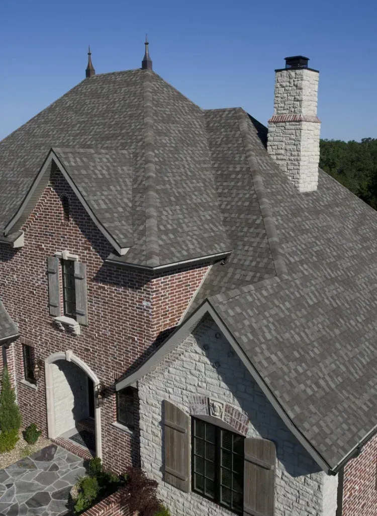 Asphalt shingles installed on a brick residential home in Maryland.
