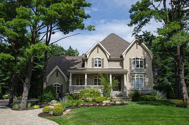 Asphalt shingle roof installation on a grey residential home in Laurel, Maryland.