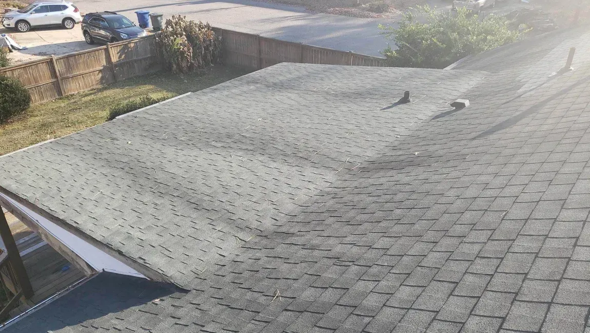 Low slope asphalt shingle roofing on a commercial building in Maryland.