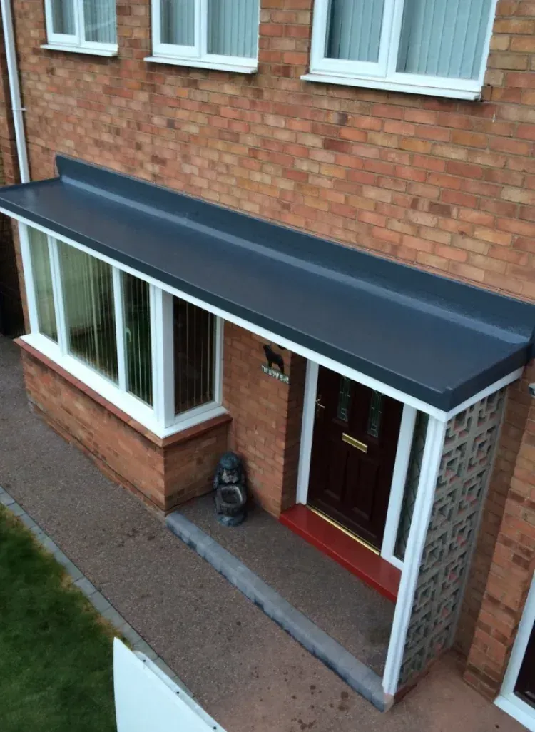 Flat roofing membrane installation on a brick residential home in Maryland