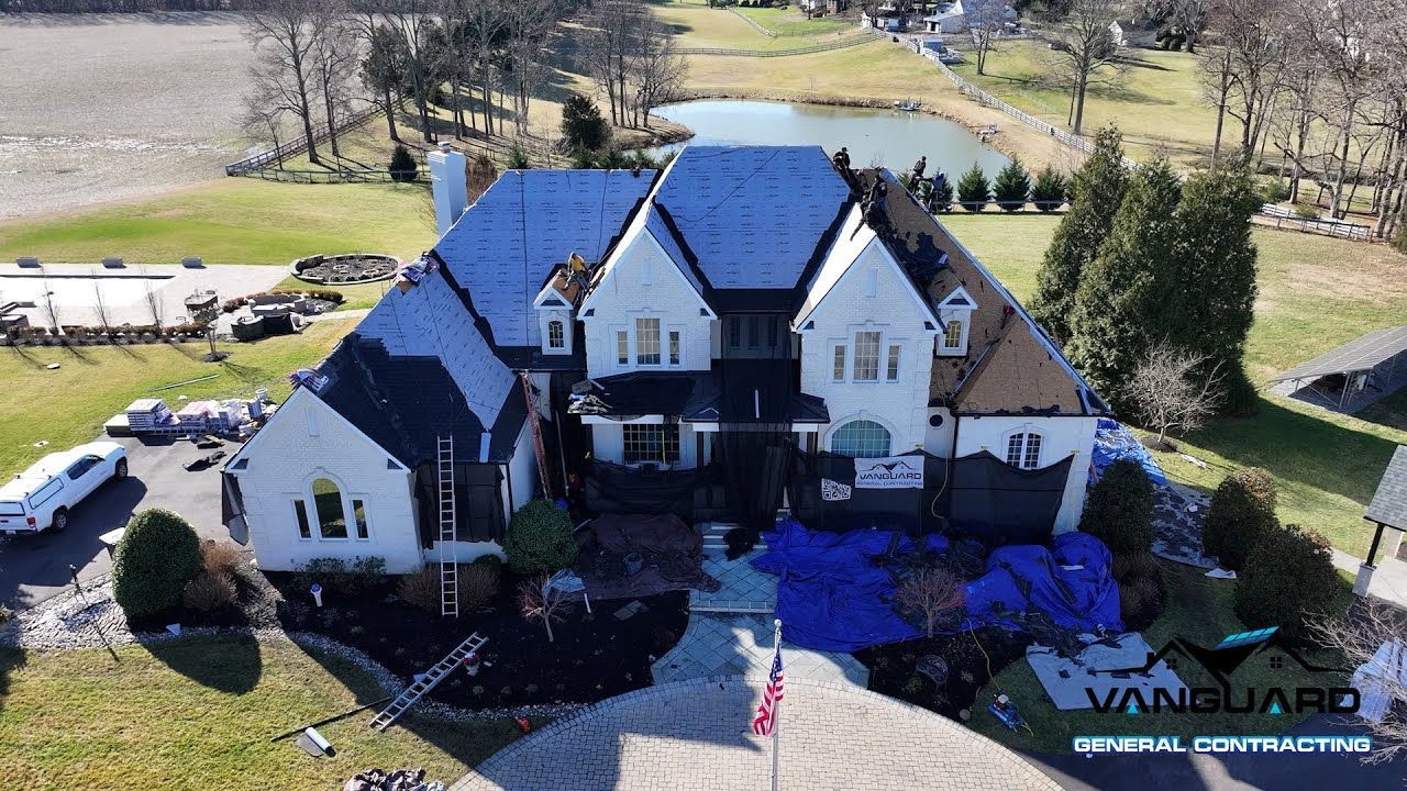 Installation of synthetic roof on a large white residential estate with gabled roofs in Maryland.
