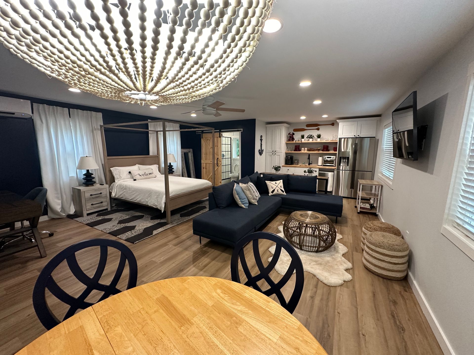 A living room with a bed , couch , table and chairs.