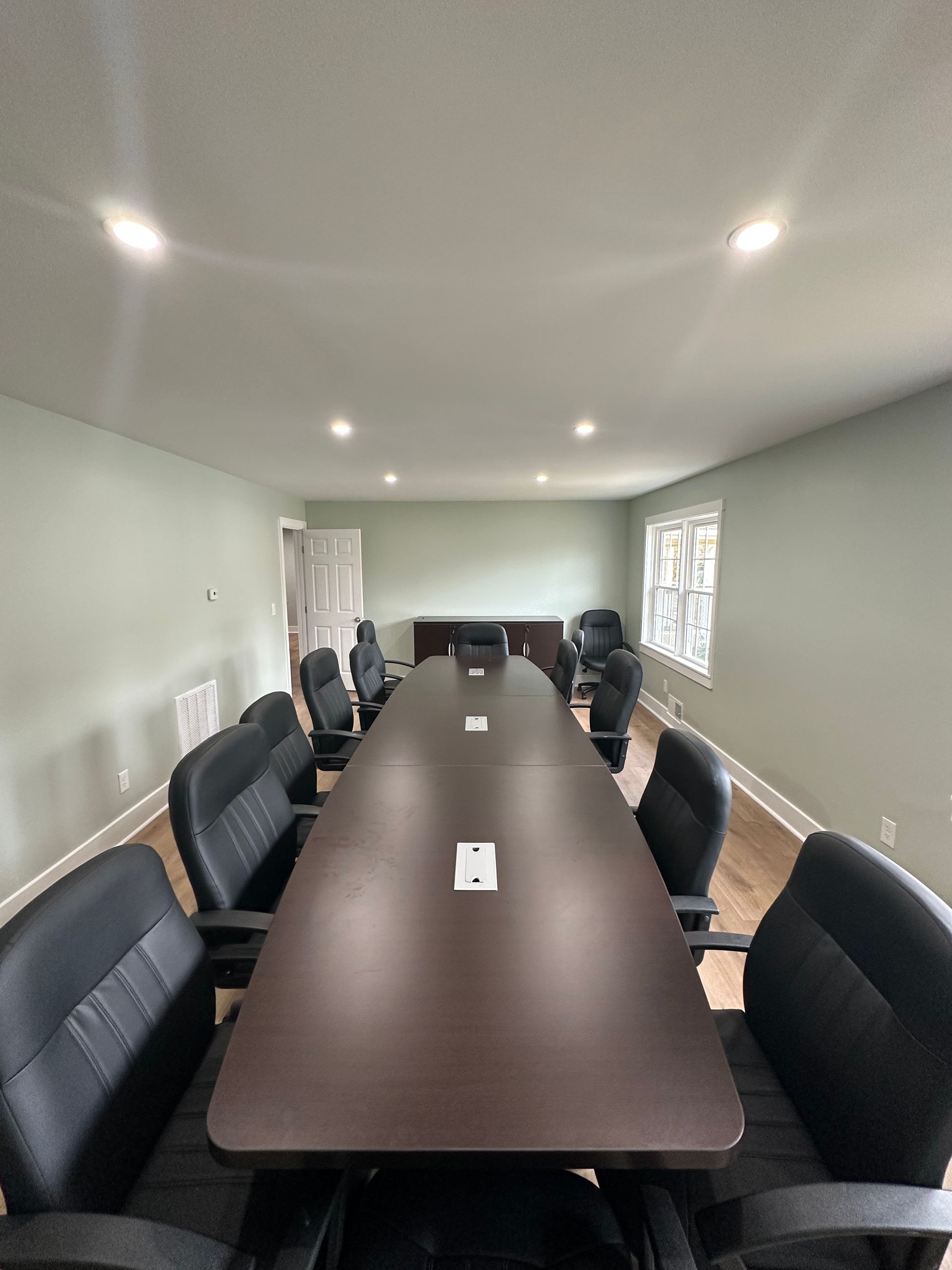 A conference room with a long table and chairs