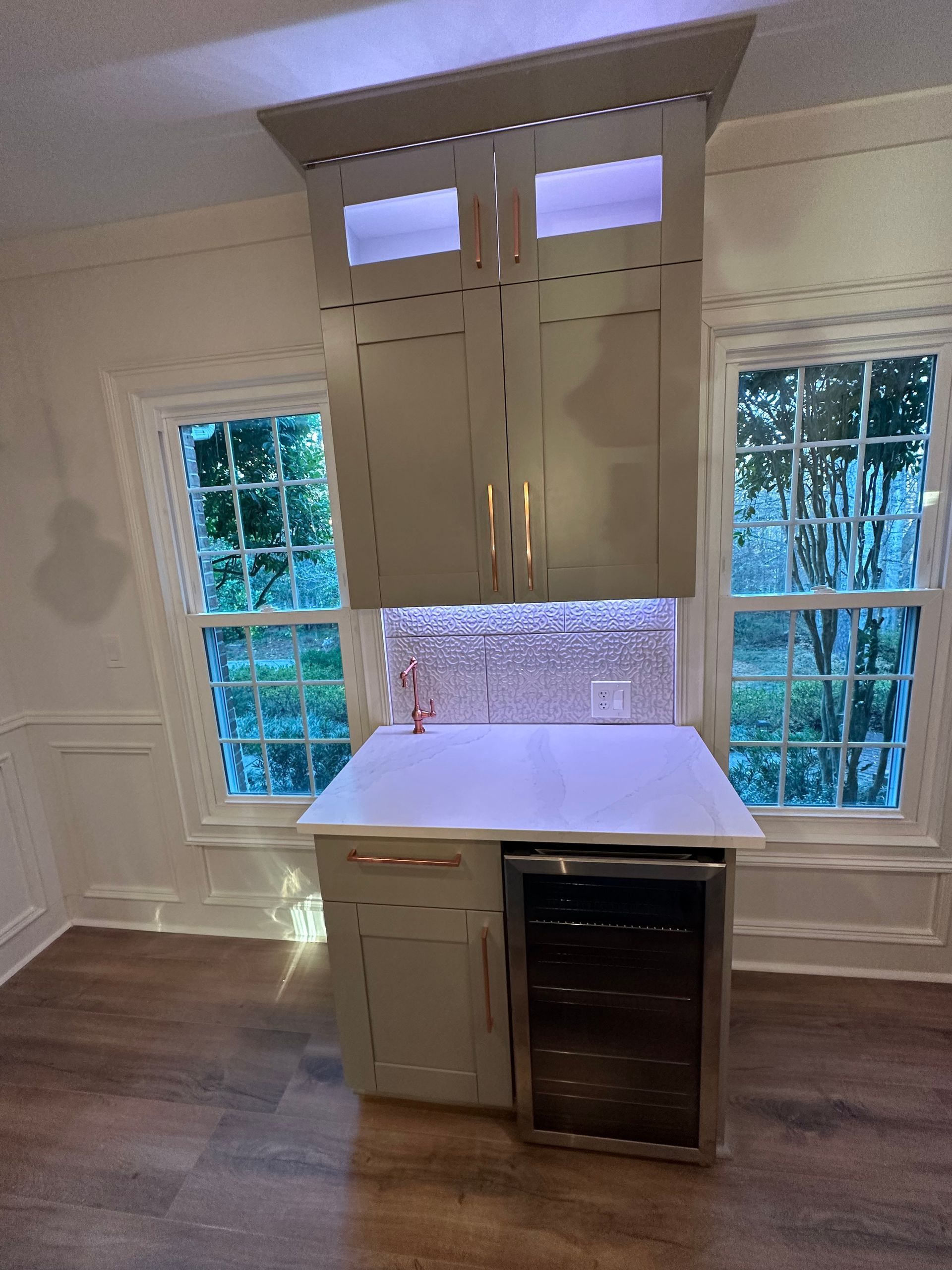 A kitchen with a refrigerator , sink , and cabinets.