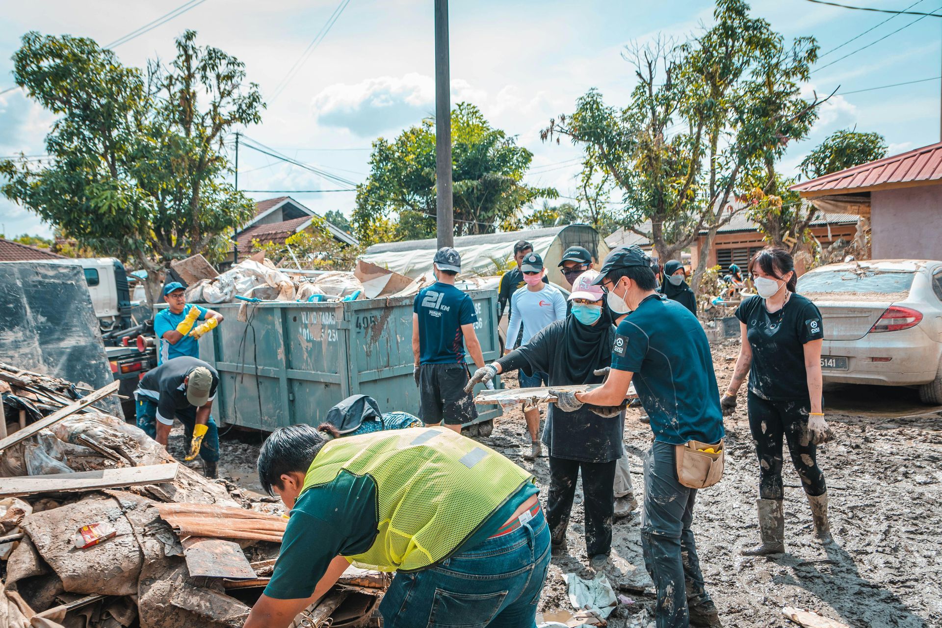 A group of people are working on a flooded street.