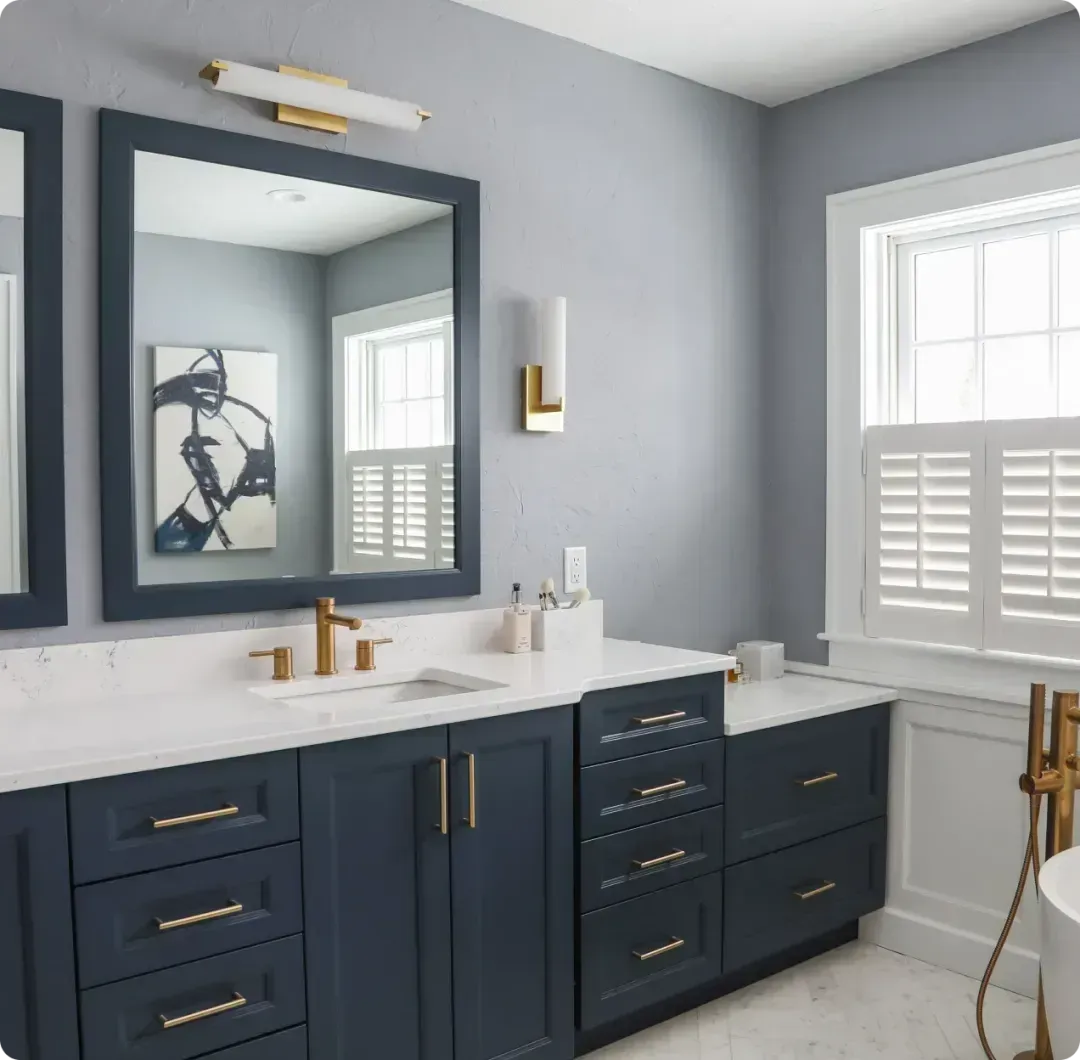 A bathroom with two sinks , a toilet , and a large mirror.