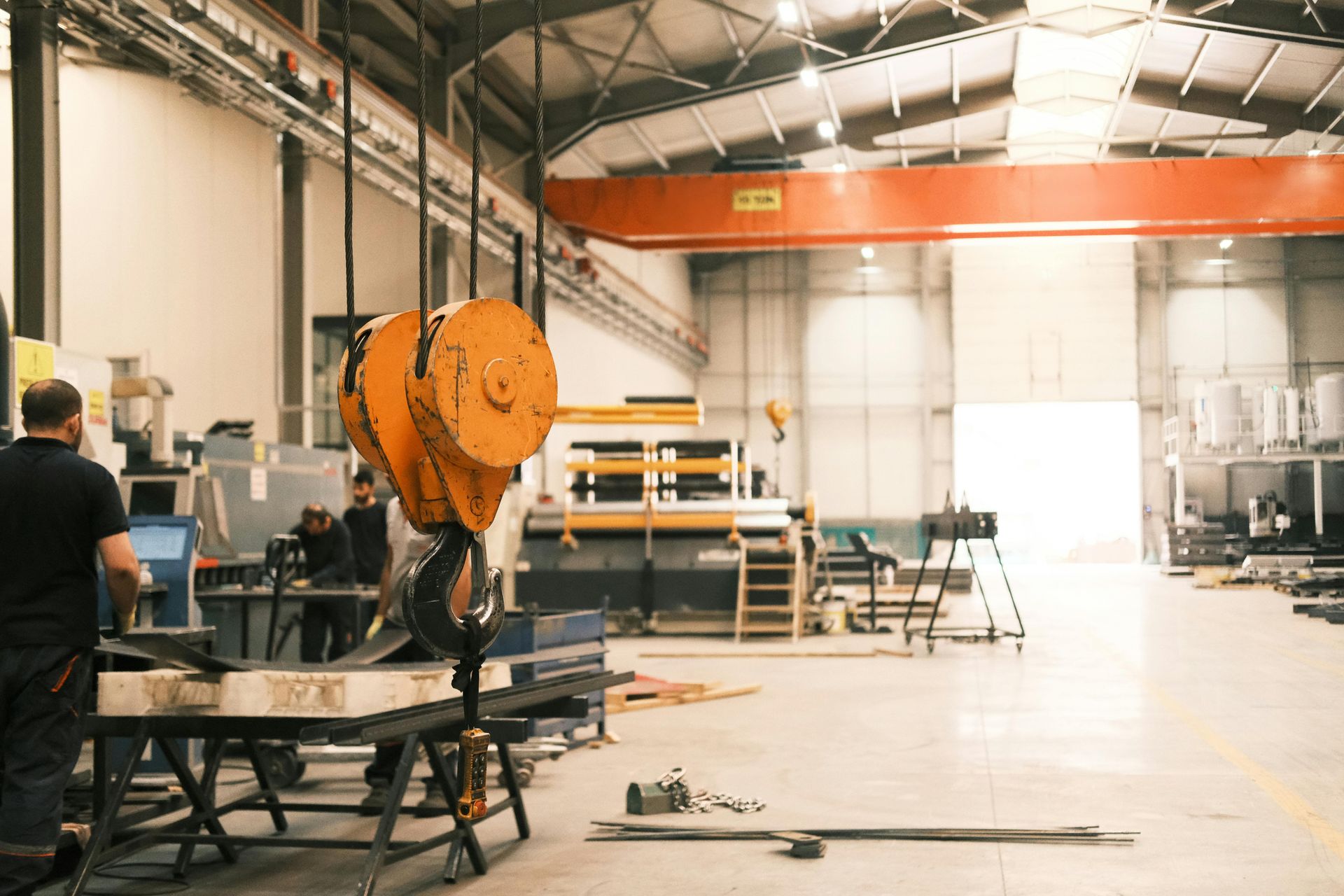 A man is working on a machine in a factory.