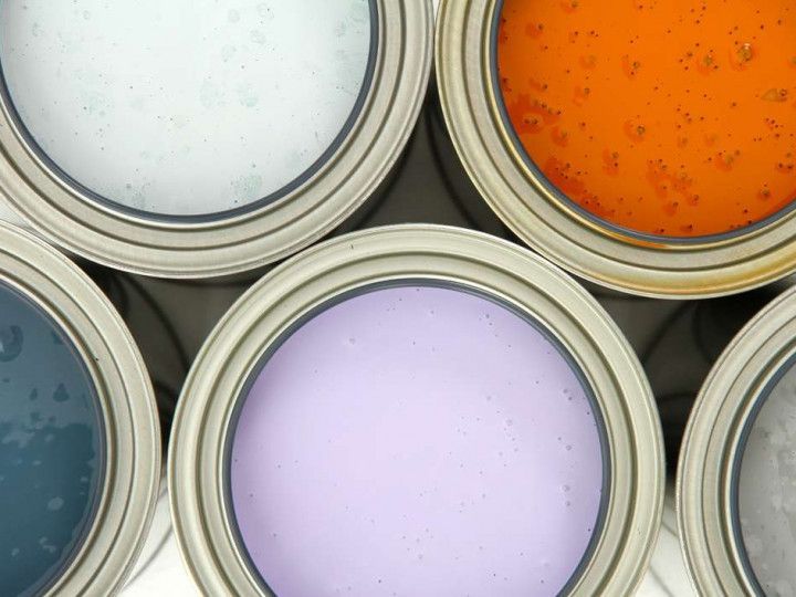Several cans of paint are stacked on top of each other
