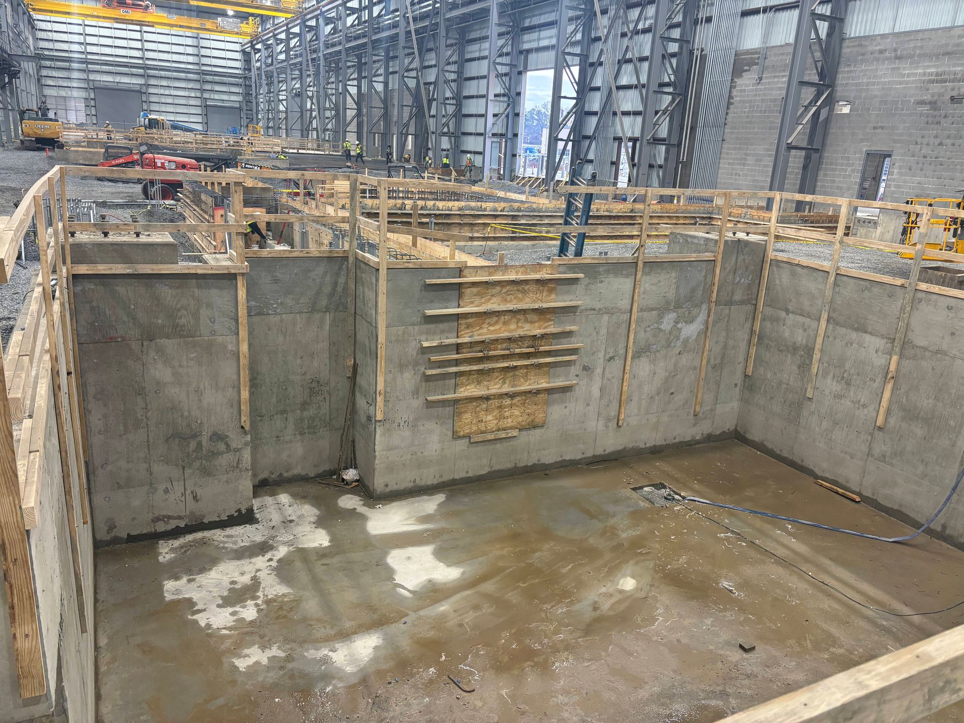 A yellow spirit level resting on a light-colored wooden surface, showing a centered bubble.