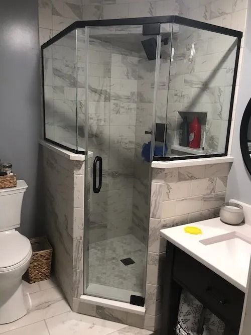 Modern bathroom with a glass shower enclosure and a vanity.