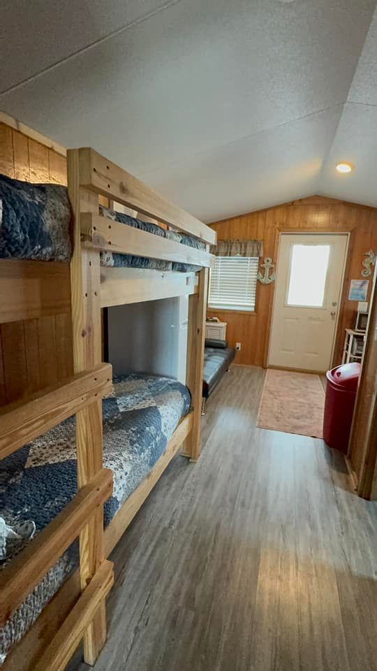A room with bunk beds in it and a door.