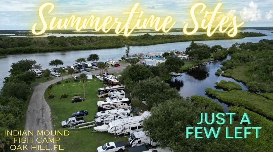 Aerial view of a campground with a river in the background.