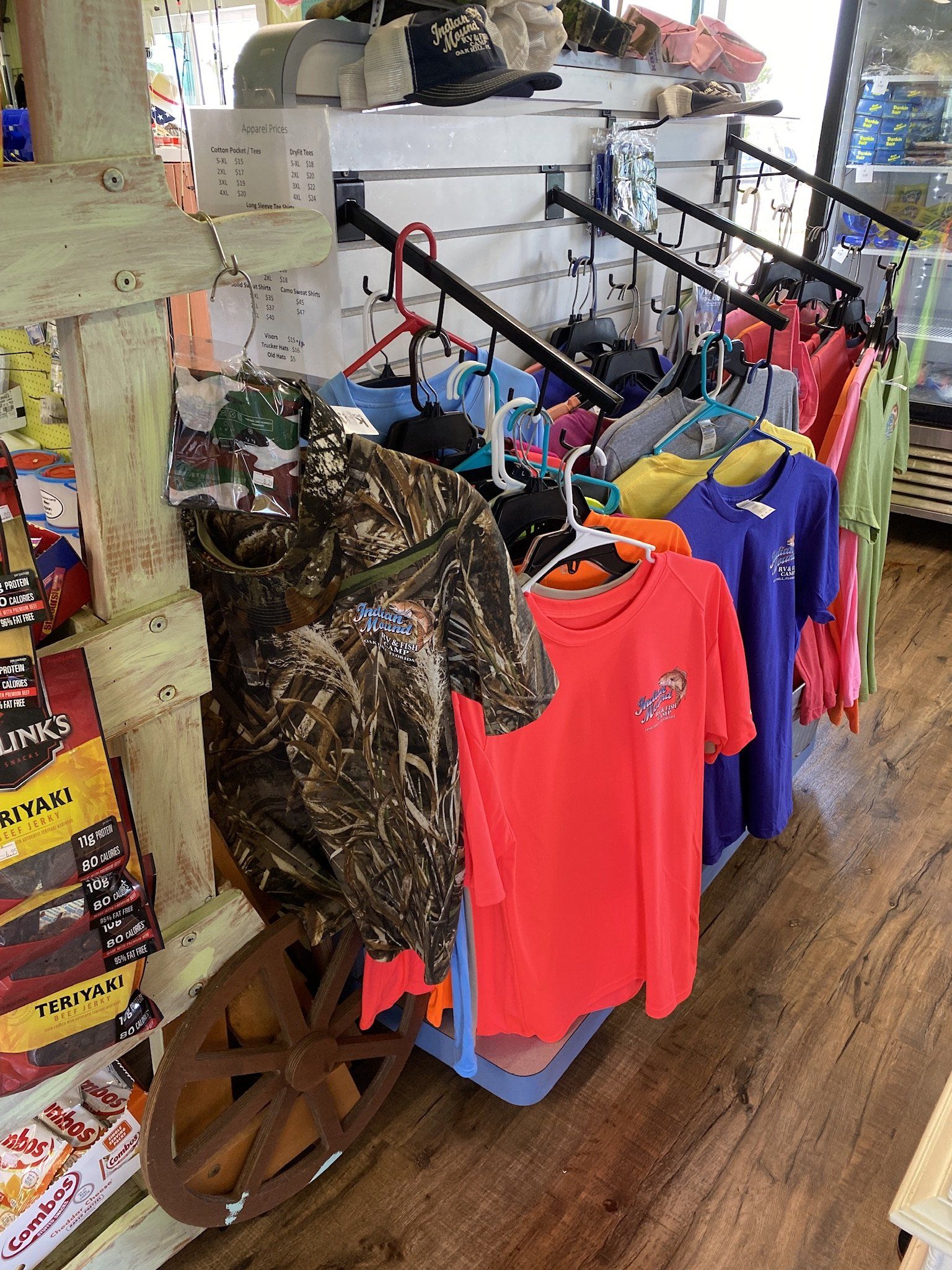 A bunch of shirts are hanging on a rack in a store.