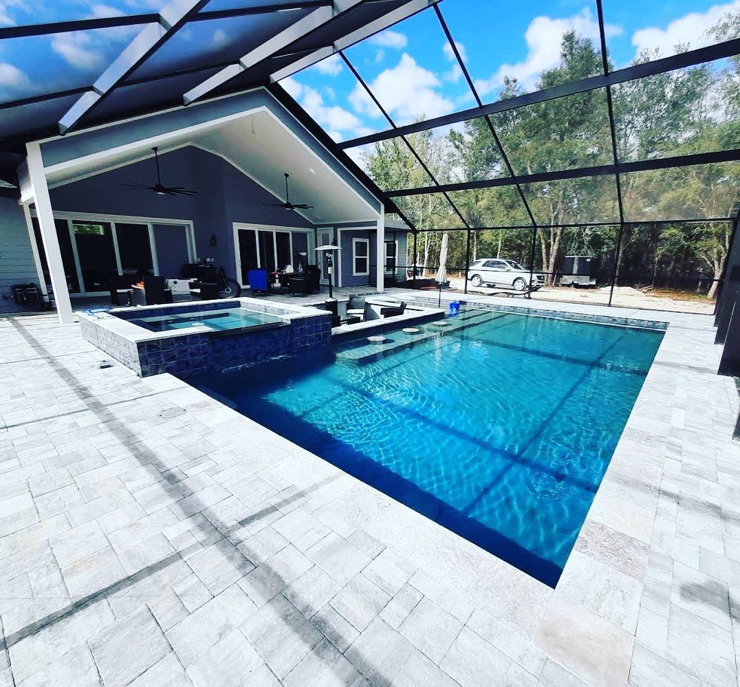 Custom geometric pool and spa with concrete paver deck 