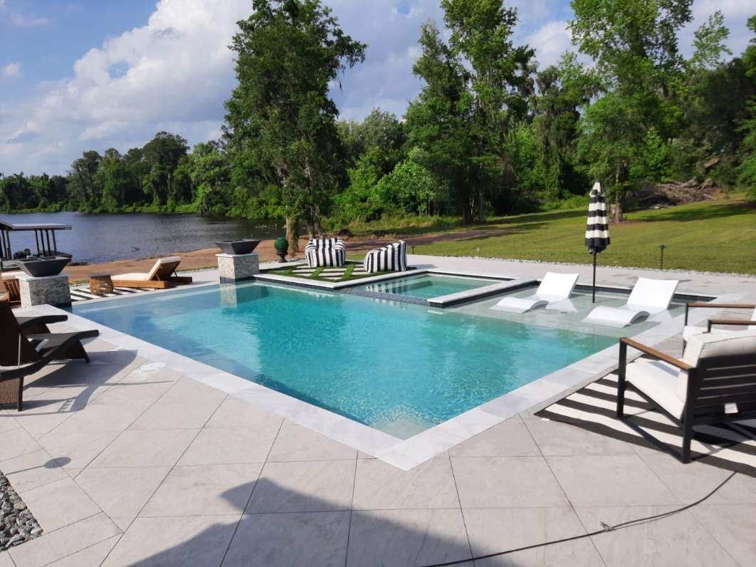 Geometric pool with travertine deck