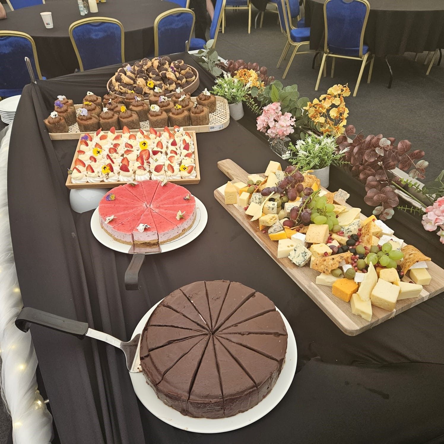A tray of desserts with whipped cream and strawberries on top