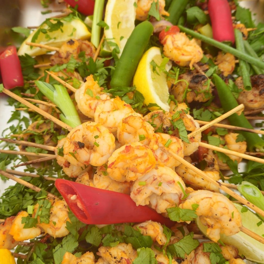 A close up of a plate of food with shrimp and vegetables