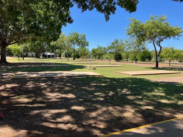 Grassy Park With Trees Under a Blue Sky, Camping Areas Visible — Karumba Point Holiday Tourist Park in Karumba, QLD