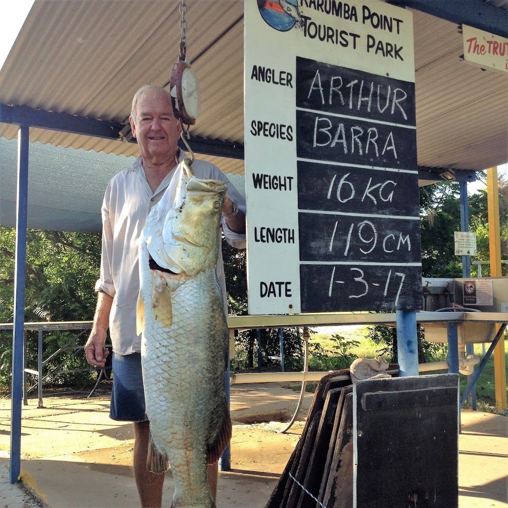 Man Holding a Large Fish He Caught, With a Sign Showing It Weighed — Karumba Point Holiday Tourist Park in Karumba, QLD