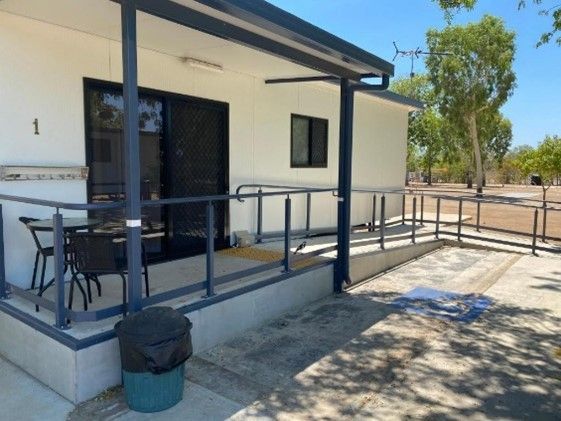 White Cabin With a Ramp, Porch, and a Black Table and Chairs — Karumba Point Holiday Tourist Park in Karumba, QLD