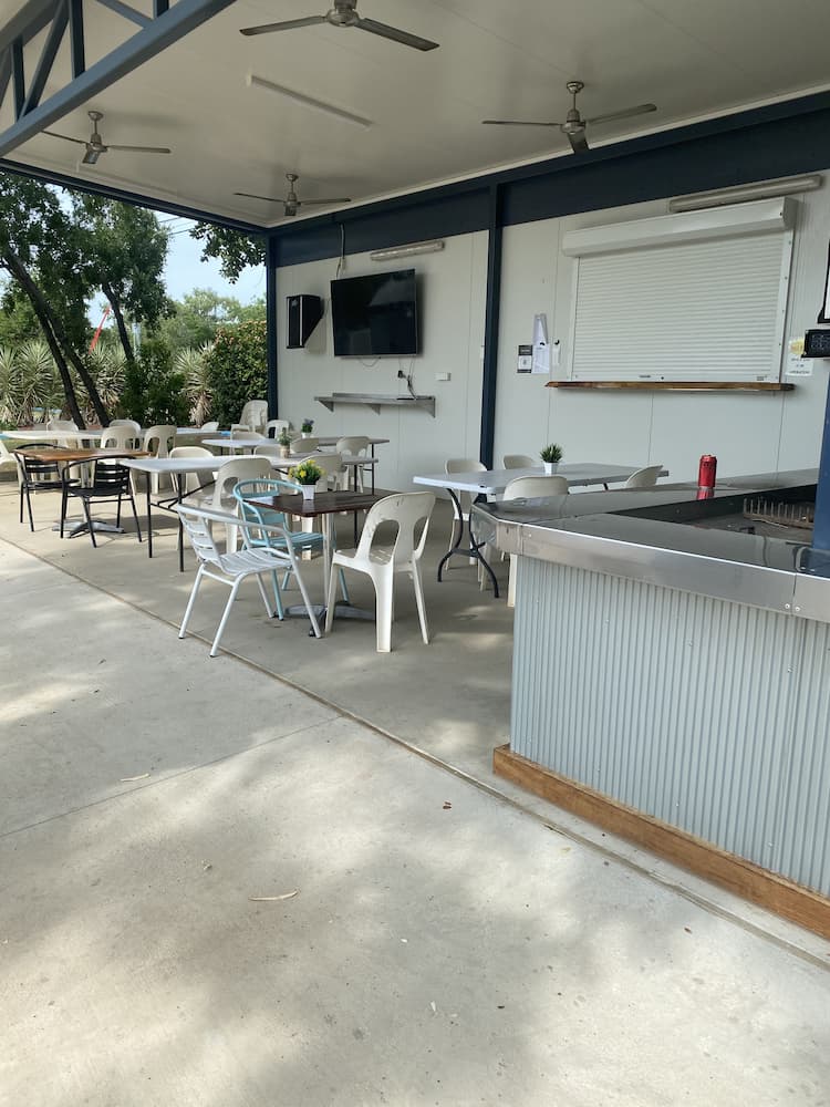 Outdoor Seating Area Under a Covered Patio With Tables and Chairs — Karumba Point Holiday Tourist Park in Karumba, QLD