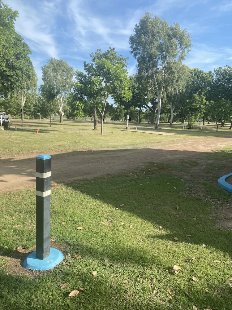Grassy Park With Trees Under a Blue Sky — Karumba Point Holiday Tourist Park in Karumba, QLD