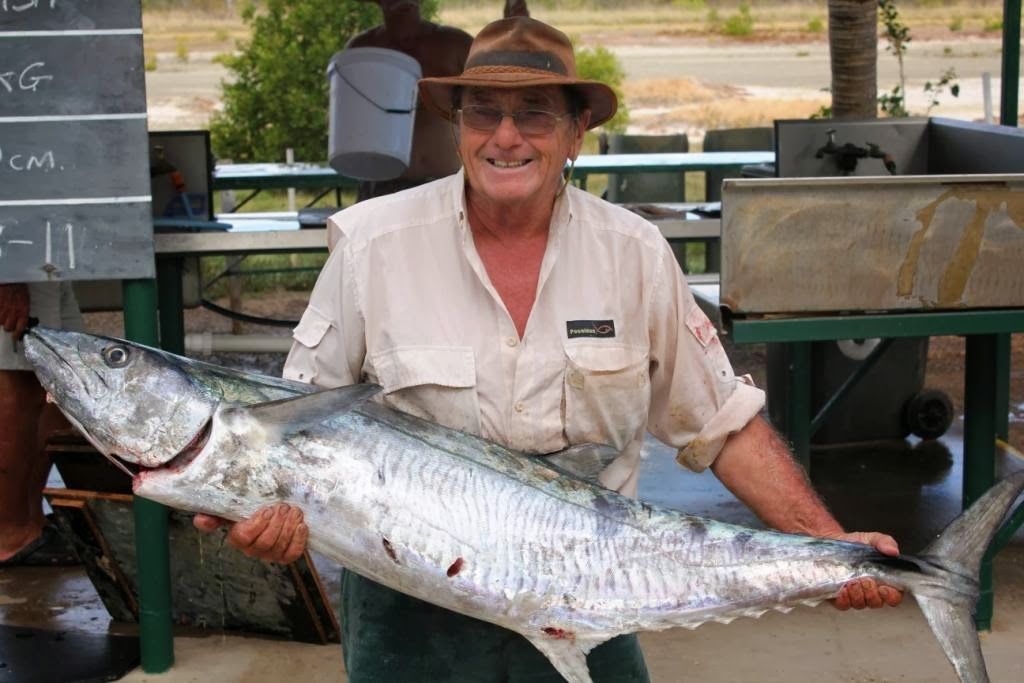 A Man in a Hat is Holding a Large Fish in His Hands — Karumba Point Holiday Tourist Park in Karumba, QLD