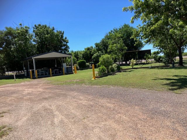 Gravel Parking Area Next to a Grassy Area With Trees — Karumba Point Holiday Tourist Park in Karumba, QLD