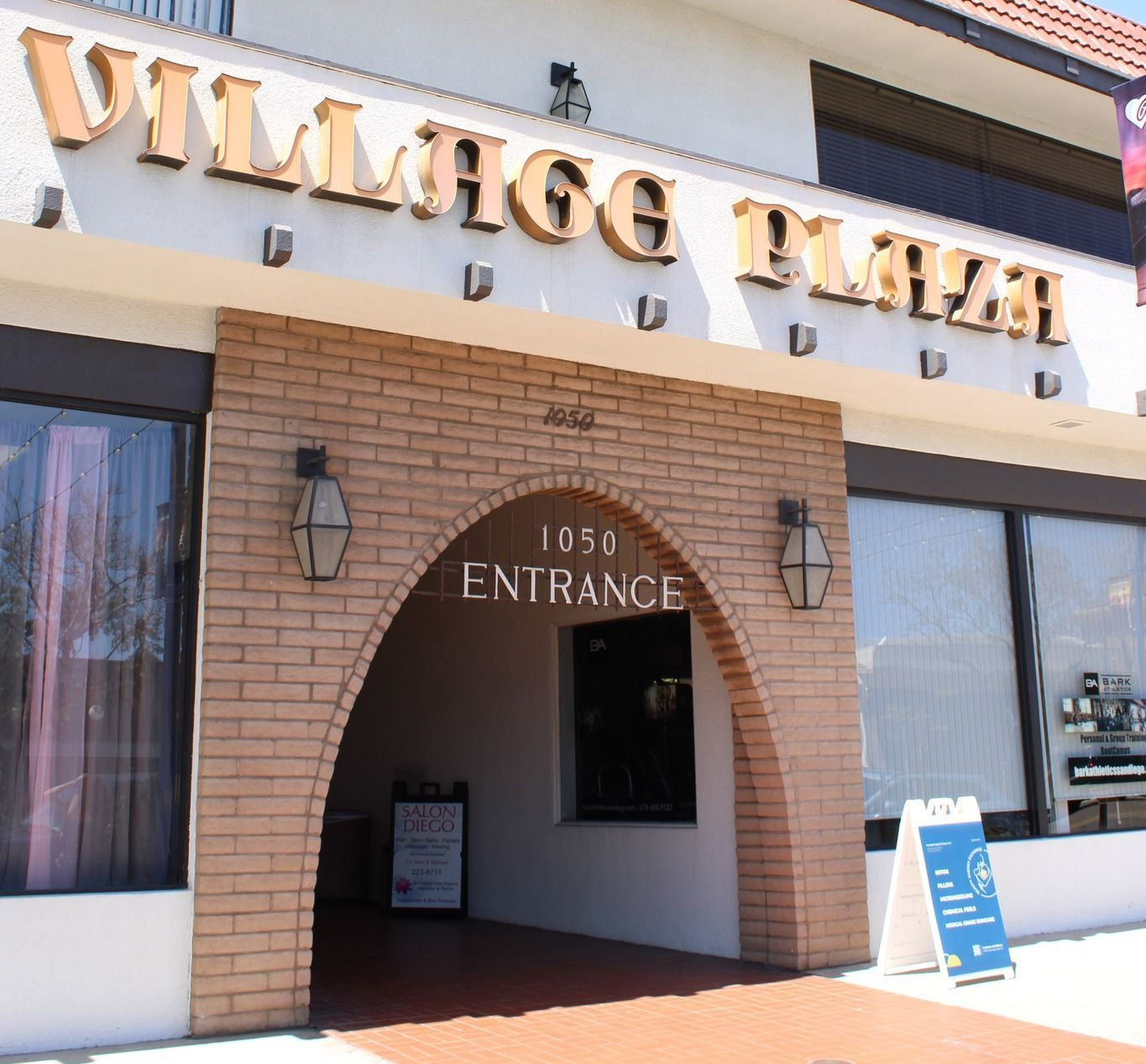 The entrance to village plaza has a brick archway The entrance to village plaza has a brick archway