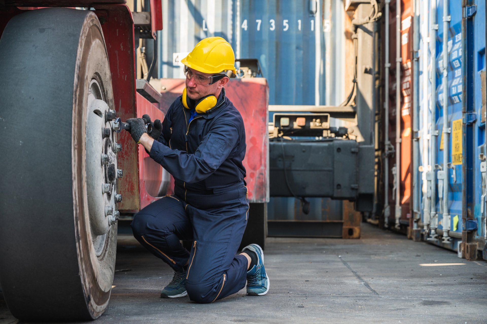 a worker performing maintenance on a mobile crane
