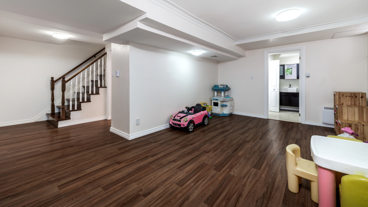 There is a pink toy car in the middle of the room.