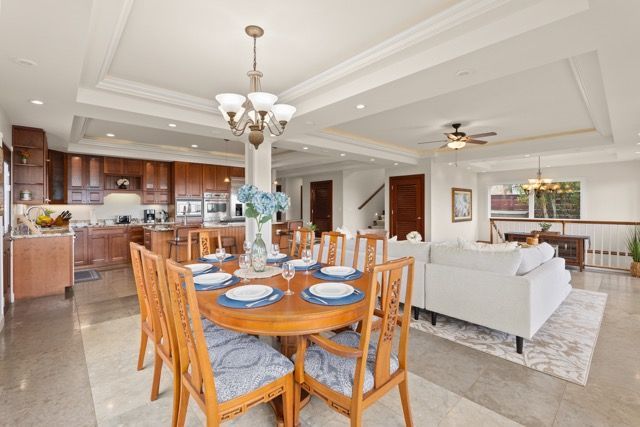 There is a dining table and chairs in the middle of the room.