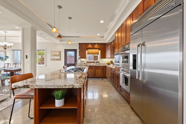 A kitchen with stainless steel appliances and granite counter tops.