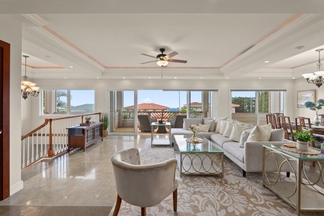 A living room filled with furniture and a ceiling fan.
