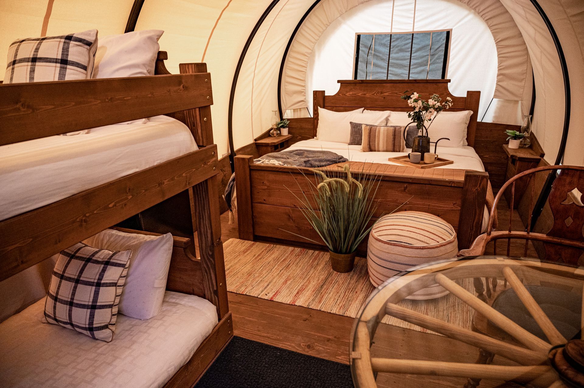 A wagon with bunk beds and a bed inside of it.