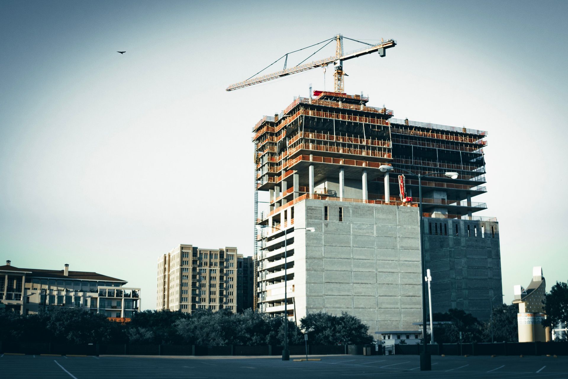 Commercial building under construction with crane illustrating builders risk insurance coverage